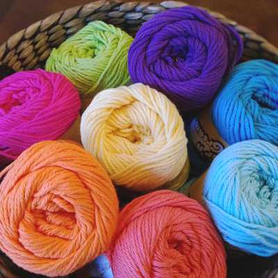 What are the different types of yarn? Image shows a basket for colourful balls of yarn | Yarn Worx