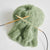 Green yarn with knitting needles on a white background | Yarn Worx