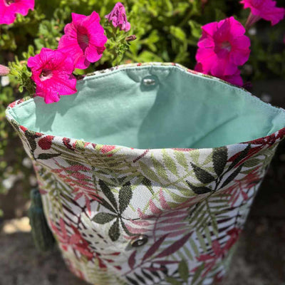 Floral-patterned fabric pouch with pink flowers in the background