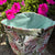 Floral-patterned fabric pouch with pink flowers in the background