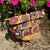 Colorful patterned fabric project bag on a wooden stool with flowers in the background