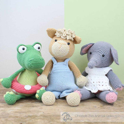 Three crocheted toys: a frog, a sheep, and an elephant, on a wooden surface with a light background | Yarn Worx