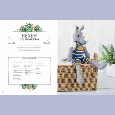 Knitted rhinoceros toy with a striped sweater on a wooden shelf, surrounded by plants | Yarn Worx