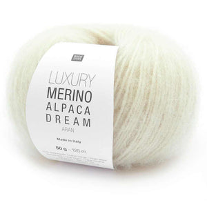 Ball of cream coloured yarn with a label indicating 'Luxury Merino Alpaca Dream' on a white background | Yarn Worx