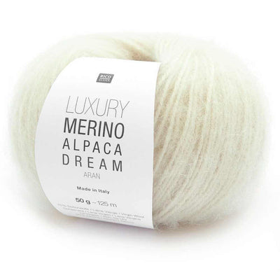 Ball of cream coloured yarn with a label indicating 'Luxury Merino Alpaca Dream' on a white background | Yarn Worx