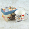 Mug with dog illustrations next to a decorative box on a textured surface | Yarn Worx