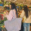 Two women shopping in a grocery store with a focus on carrying a raindrop tote bag | Yarn Worx