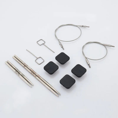 Collection of knitting needles and accessories on a white background | Yarn Worx