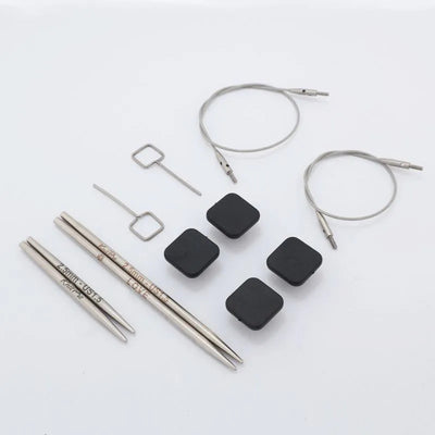 Collection of knitting needles and accessories on a white background | Yarn Worx