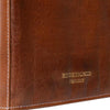 Close-up of a brown leather product corner with visible white stitching and gold embossed text reading 'REDESIGNED PROJECT' | Yarn Worx