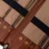 Close-up of a leather tool roll with various sizes of needles inside, on a beige background | Yarn Worx