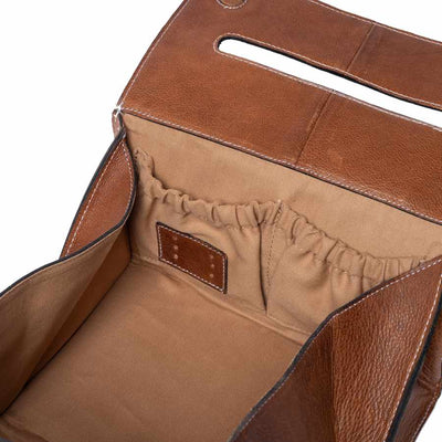 Close-up of a brown leather project bag interior showing a tan fabric lining with an elastic pocket and a small brown leather patch | Yarn Worx