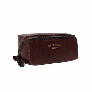 A dark burgundy leather zippered pouch with gold embossed branding on the front, set against a plain white background | Yarn Worx