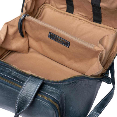 Re:Designed Project 39 Sapphire Blue leather travel bag with dual top handles, a front zippered pocket, and a diagonal zipper, shown on a plain white background.