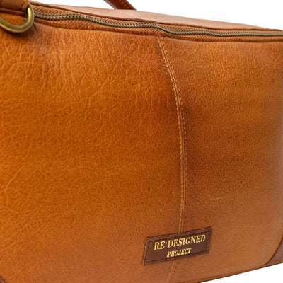 Brown leather bag with 'Re:Designed Project' label on a white background | Yarn Worx