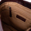 Close-up of a brown leather bag with a visible brand label | Yarn Worx