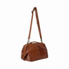A medium brown textured leather duffel bag with a long adjustable shoulder strap and top handle, shown from a side profile on a plain white background | Yarn Worx