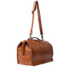 A brown leather doctors style bag with a top handle, adjustable shoulder strap, and burnished style hardware, shown on a plain white background | Yarn Worx