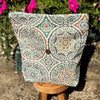 Decorative pillow with a pattern on a stool outdoors
