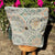 Decorative pillow with a pattern on a stool outdoors