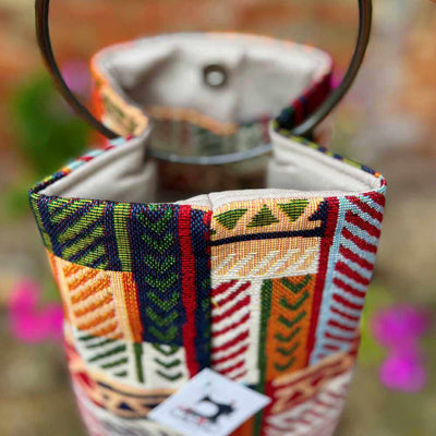 Colorful embroidered fabric pouch with a blurred background