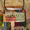 Colorful patterned bag with a blurred background