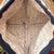 Close-up of a patterned fabric interior with visible stitching
