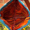 Close-up of a colorful fabric pouch with a patterned interior.