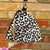 Leopard print pouch with tassel on a brick wall background