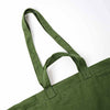 Close-up of an olive green canvas tote bag with double shoulder straps, showing the fabric texture and stitching against a plain white background | Yarn Worx