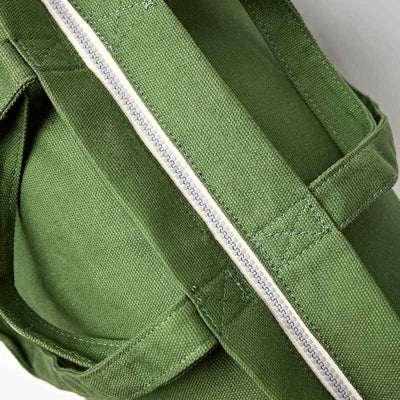 Close-up of a green bag with a strap, focusing on the texture and stitching details | Yarn Worx