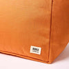 Close-up of an orange bag with a Roka London label on a white background | Yarn Worx