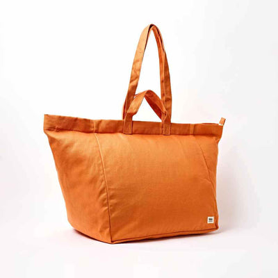 An orange canvas tote bag with dual top handles, photographed on a clean white background | Yarn Worx