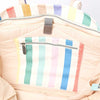 Close-up of a pastel striped pouch with a zipper on a light background | Yarn Worx