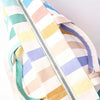 Colorful striped bag with a zipper on a light gray background | Yarn Worx