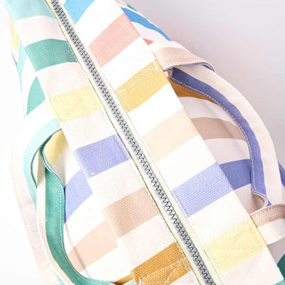 Colorful striped bag with a zipper on a light gray background | Yarn Worx