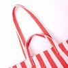 Close-up of a red and pink striped bag with a handle on a white background | Yarn Worx