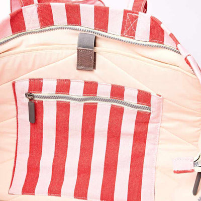 Close-up of a backpack with red and pink striped pocket on a beige background | Yarn Worx