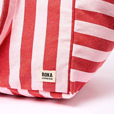 Red and pink striped bag with Roka London label on a light pink background | Yarn Worx