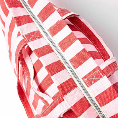 Close-up of a red and pink striped fabric with a zipper | Yarn Worx
