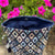 Patterned fabric bag with pink flowers in the background