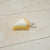 Keychain shaped like a slice of pie on a light wooden surface