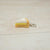 Miniature keychain of a slice of cake on a light wooden surface