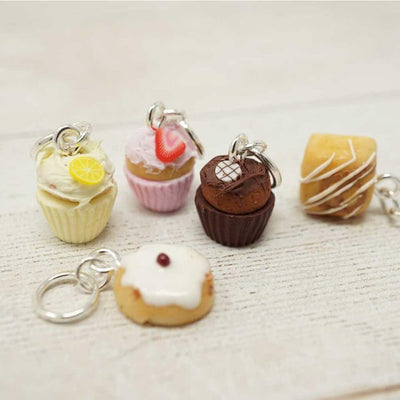 Miniature dessert keychains on a light background