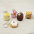 Miniature dessert keychains on a light background