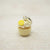 Cupcake-shaped keychain with lemon on a light wooden surface