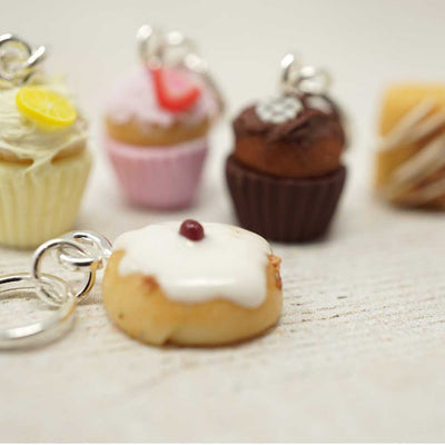 Donut-shaped keychain with other donut-themed items on a light surface