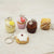 Set of miniature dessert keychains on a light background