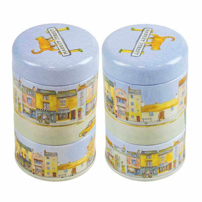 Two cylindrical tins with decorative lids featuring illustrations of buildings and a ginger cat on the lid | Yarn Worx