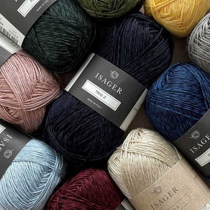 Assorted balls of yarn with Isager labels in various colors.